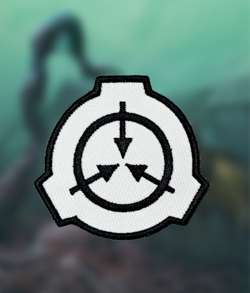 May include: White embroidered patch with a black circle and three black arrows pointing inward. The circle has a black border and the arrows are inside the circle.