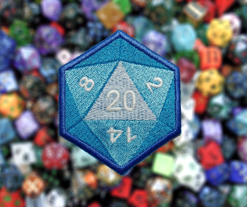 May include: A blue 20-sided die with white numbers, a popular item for tabletop role-playing games. The die is embroidered with a blue and white design.
