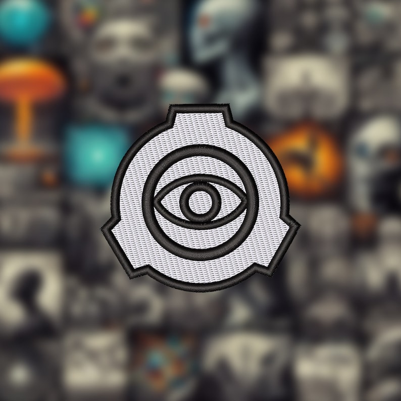May include: A white and black embroidered patch with a stylized eye inside a circle. The circle is surrounded by a black ring with a jagged edge.