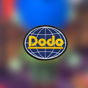 May include: A blue and white embroidered patch with a globe design and the word "Dodo" in yellow lettering.