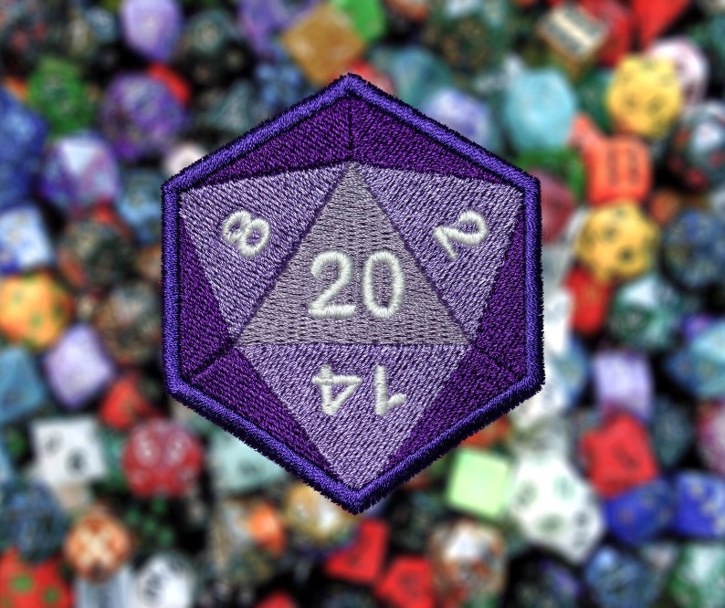 May include: Purple 20-sided die with white numbers, 3, 12, 20, and 14, embroidered on a fabric patch.