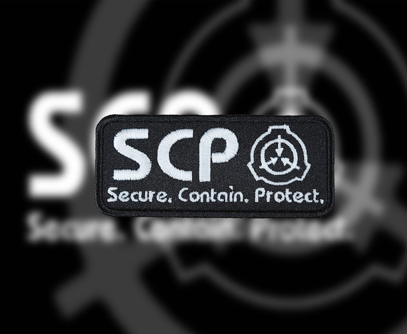 May include: Black and white embroidered patch with the text "SCP Secure. Contain. Protect." and a symbol of a circle with an arrow pointing down.