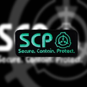 May include: Black and green embroidered patch with the text "SCP" and the SCP logo. The text below the logo reads "Secure. Contain. Protect."