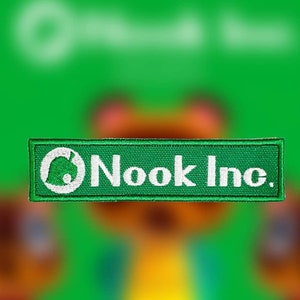 May include: A green and white embroidered patch with the text "Nook Inc." and a white silhouette of a house with a green leaf on top.