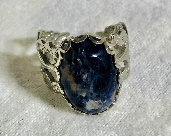 Sodalite adjustable ring encased in a White Plated Filigree Setting