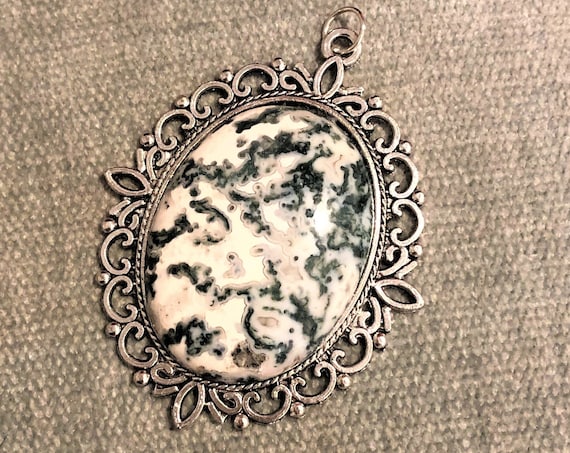This Tree Agate gemstone is set in a lovely silver-plated back and comes with a 24 inch Sterling Silver Chain.