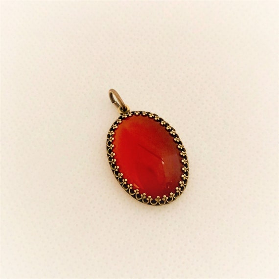 This Carnelian Cabochon is set in a brass setting and includes an oxidized copper adjustable chain.
