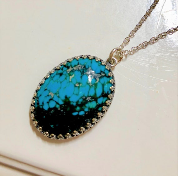 Chinese Turquoise Cabochon Pendant set in a Silver Plated Setting.