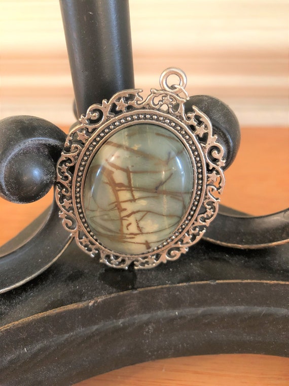 Picasso Jasper Cabochon resting in a Silver Plated setting.