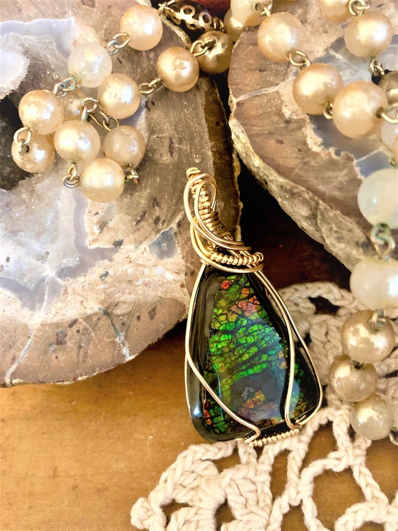 This Brilliant Ammolite Fossil is wrapped expertly in a 14K Gold Filled Wire.