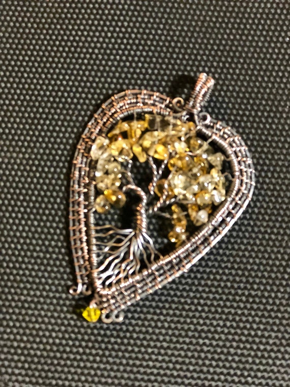 This Citrine Tree of Life Pendant emanates positivity and joy.