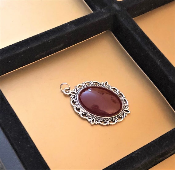 Carnelian Cabochon encased in a Silver Plated Setting.