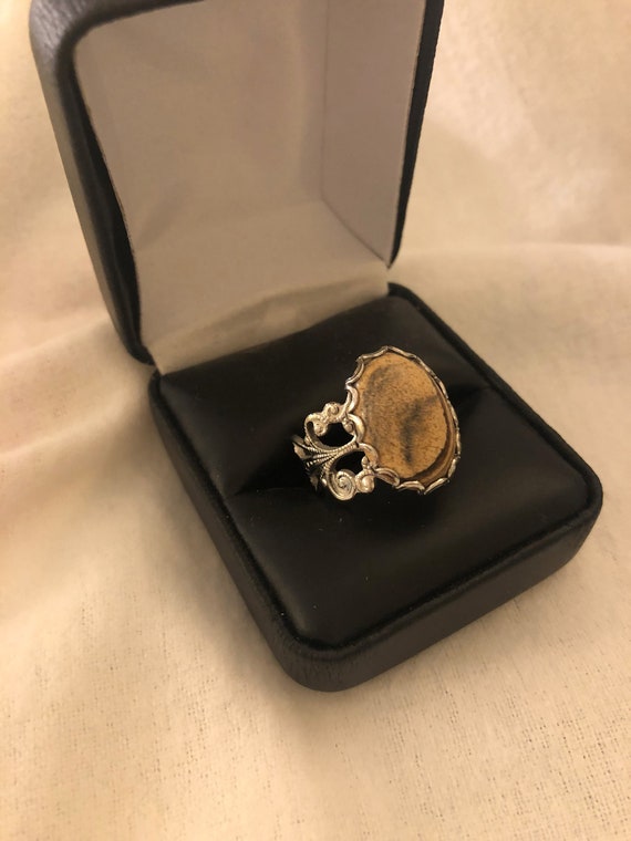 Picture Jasper adjustable ring encased in a White Plated Filigree Setting.