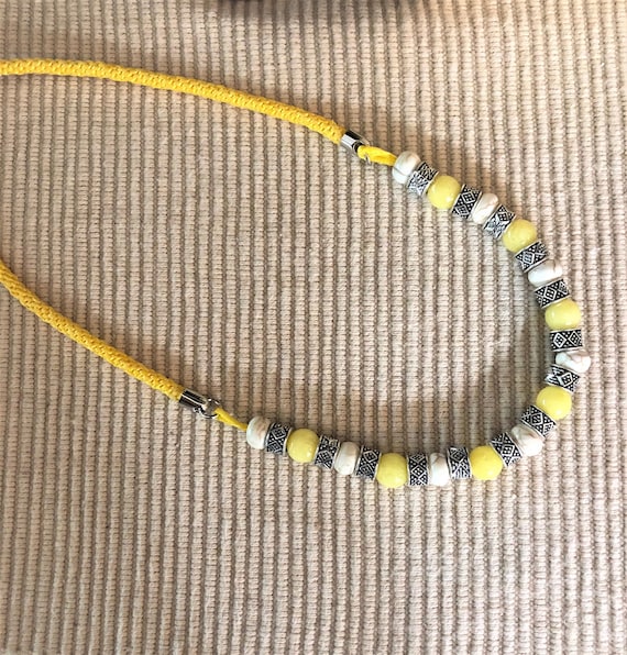 Nylon Satin cord hand braided 18 inch necklace accented with Yellow Icy Jade, Howlite and Silver Plated Beads.