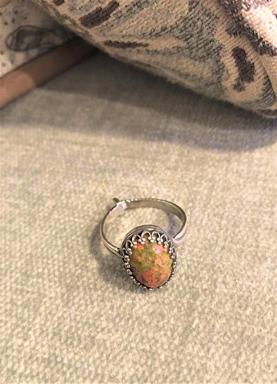 Unakite adjustable ring encased in a silver-plated crown bezel.