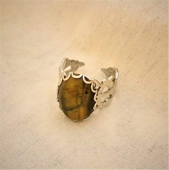 Tiger Eye Jasper adjustable ring encased in a White Plated Filigree Setting.