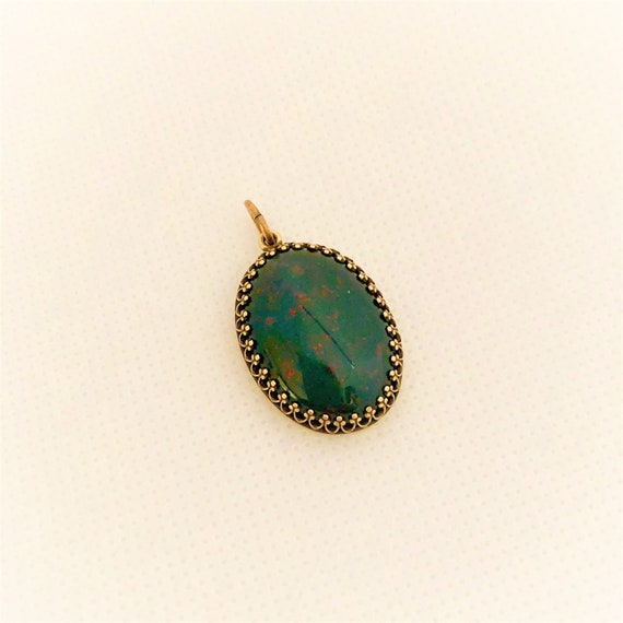 This Bloodstone Cabochon is set in a brass crown and includes a 24" adjustable oxidized copper chain.
