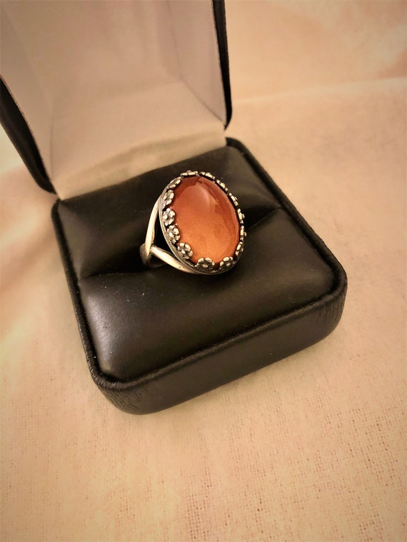 Goldstone adjustable ring encased in a Floral Silver Plated Setting.