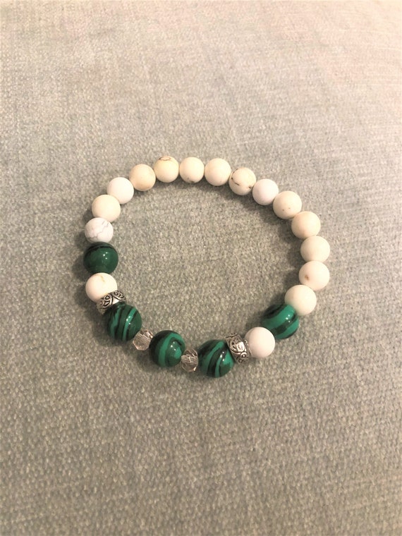 Man made Malachite stretch bracelet with Howlite, silver plated spacer beads and crystal beads.