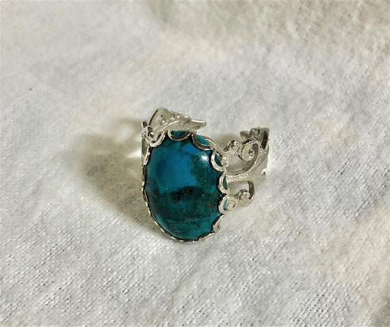 Turquoise adjustable Ring encased in a White Plated Filigree Setting