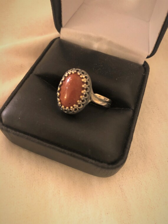 Goldstone  adjustable ring encased in a Brass Crown Bezel Setting.