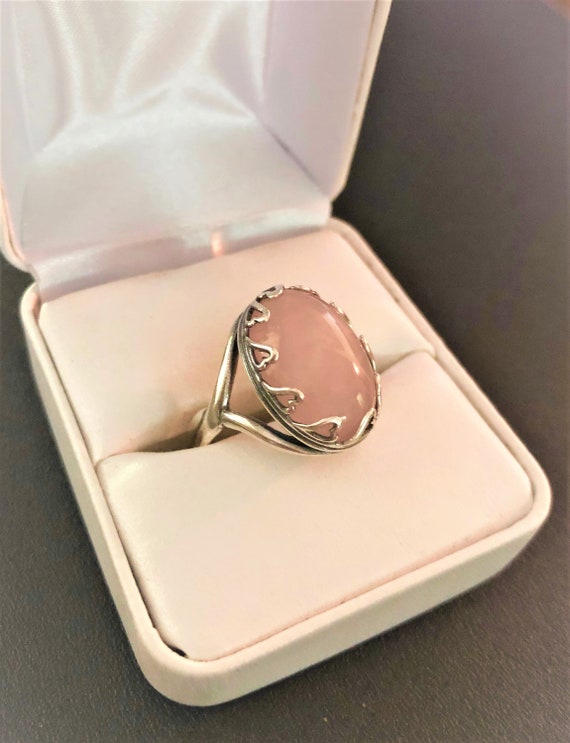 This adjustable Rose Quartz Ring has a silver-plated bezel of hearts setting.