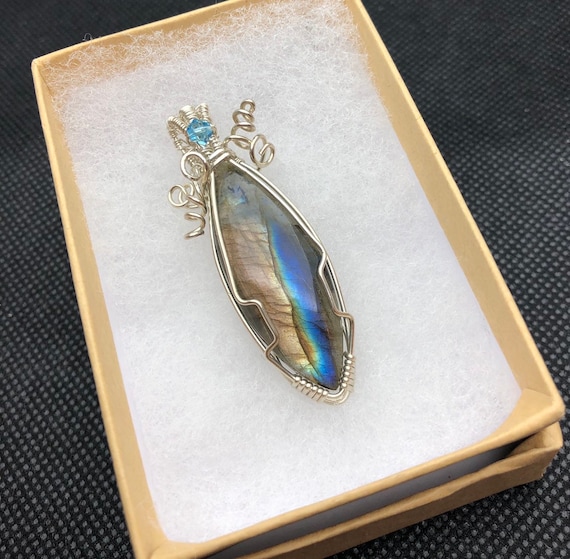 Blue Flashy Labradorite garnished with a Swarovski Crystal.   Labradorite property is  "Bringer of Light"