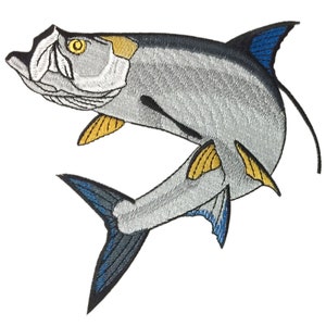 May include: A silver embroidered patch of a leaping fish with blue and yellow accents. The fish has a long, thin body and a large, pointed head.