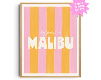 May include: A framed art print with a pink and orange striped background. The words "happiest in MALIBU" are in white, with a pink starburst that says "COMES IN MORE COLORS".