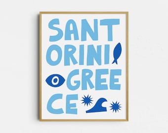May include: A framed art print with the words "SANTORINI GREECE" in light blue, stylized lettering. The design includes a fish, an eye, a wave, and starbursts. The print is in a wooden frame.