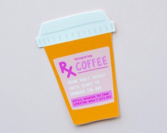 May include: An orange sticker in the shape of a prescription bottle, with a light blue lid. The sticker reads "Prescription Coffee" with instructions to "Drink Daily, Repeat" and "Refills: Whenever you yawn".