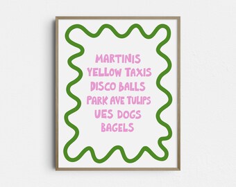 May include: A framed art print with a white background and a green wavy border. The print features a list of words in pink, including "Martinis," "Yellow Taxis," and "Disco Balls." The artwork is a decorative piece.