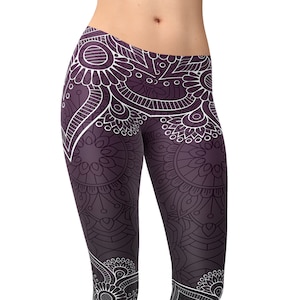 May include: Purple yoga leggings with a white mandala pattern. The leggings are full length and have a tight fit.