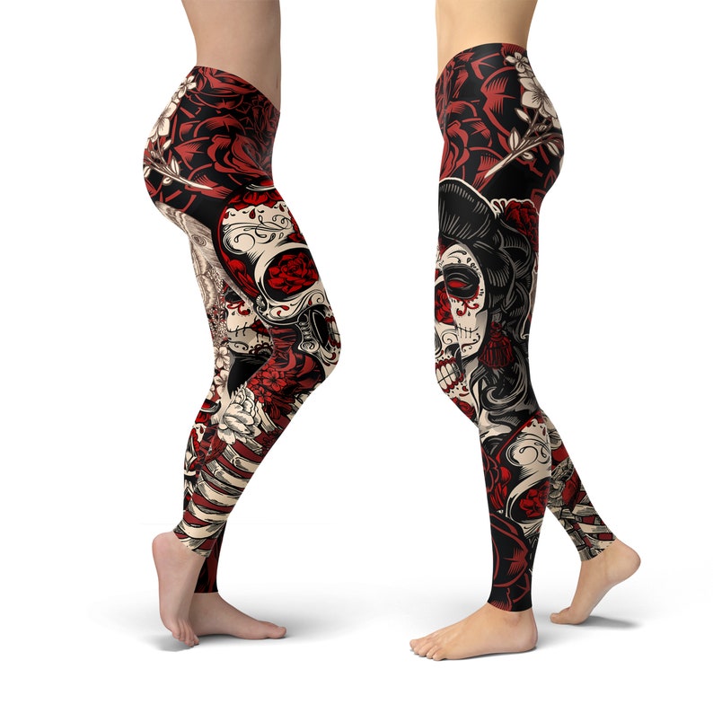 May include: Red, black, and white leggings with a skull and floral design. The skull is wearing a flower crown and has a sugar skull design.