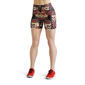 May include: Black athletic shorts with a skull and rose print. The shorts have a high waist and a fitted silhouette.