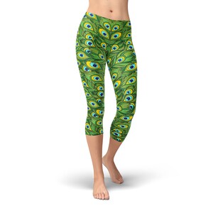 May include: Green capri leggings with a peacock feather pattern. The pattern features blue and yellow accents.