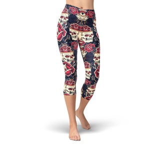 May include: Black capri leggings with a skull and rose print. The print features red roses, white skulls, and a single eye with a lightning bolt.