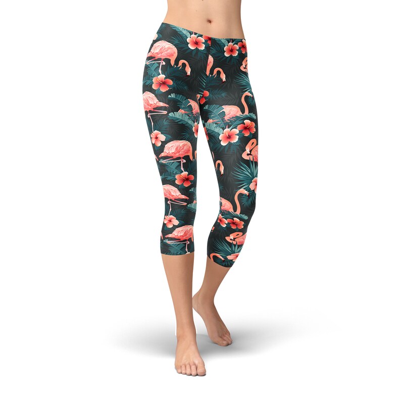 May include: Black capri leggings with a tropical print featuring pink flamingos and red flowers.