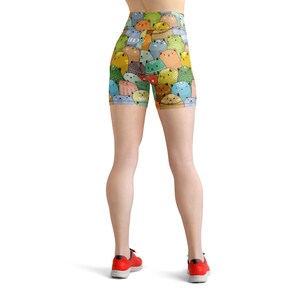 May include: A pair of athletic shorts with a colorful cat print. The shorts are made of a stretchy, comfortable fabric and are perfect for working out or running errands.