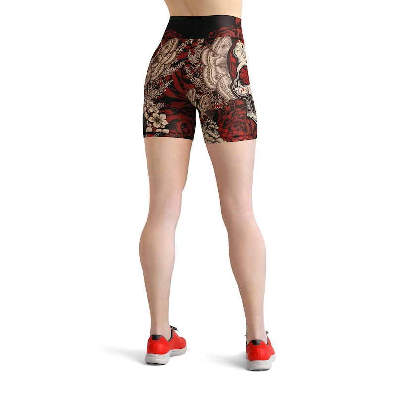 May include: Black athletic shorts with a colorful floral and skull print. The shorts have a high waist and a tight fit.