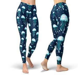May include: Blue leggings with a pattern of white jellyfish with teal tentacles on a dark blue background.