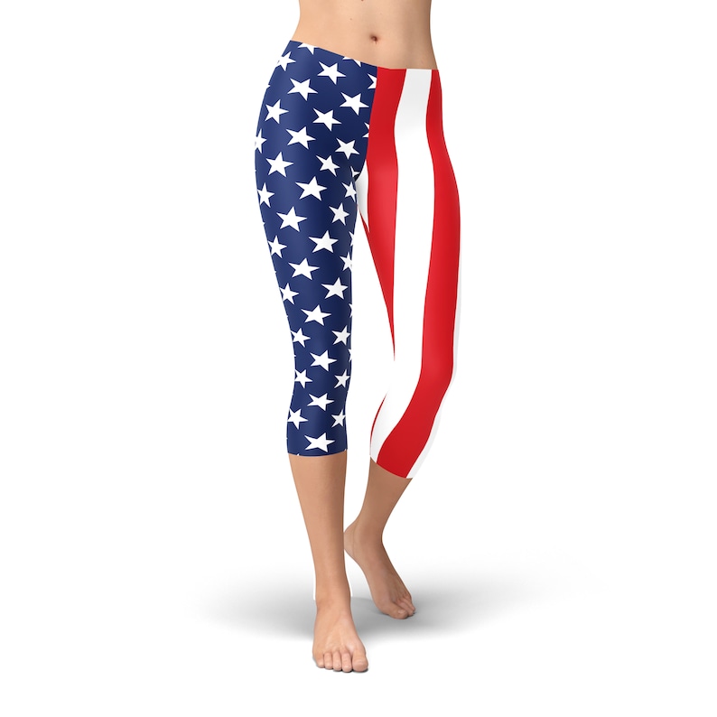 May include: A pair of blue and red leggings with a design of the American flag. The leggings are cropped and have a white background with red stripes and blue stars.