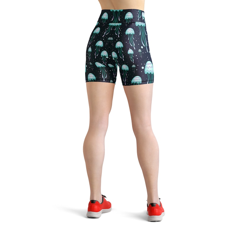 May include: Black athletic shorts with a jellyfish print. The shorts have a high waist and are made of a stretchy, comfortable fabric.