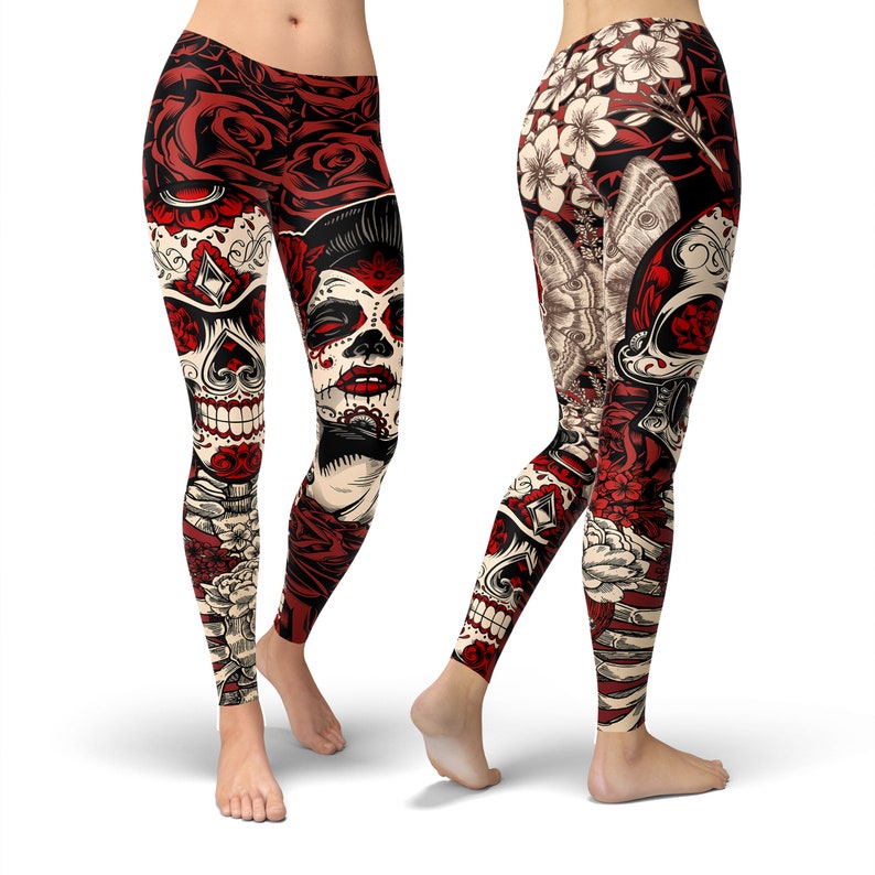 May include: Red, white, and black leggings with a skull and flower design. The leggings feature a sugar skull with flowers and butterflies.