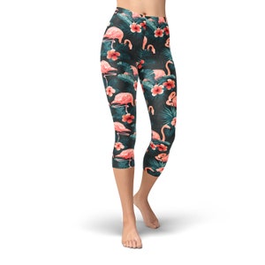 May include: Black capri leggings with a tropical print featuring pink flamingos and red flowers.