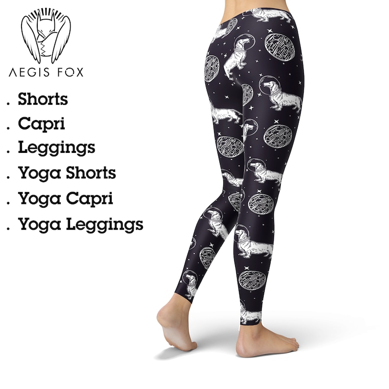 May include: Black leggings with a white print of dachshunds wearing astronaut helmets and floating in space. The print also includes stars and planets.