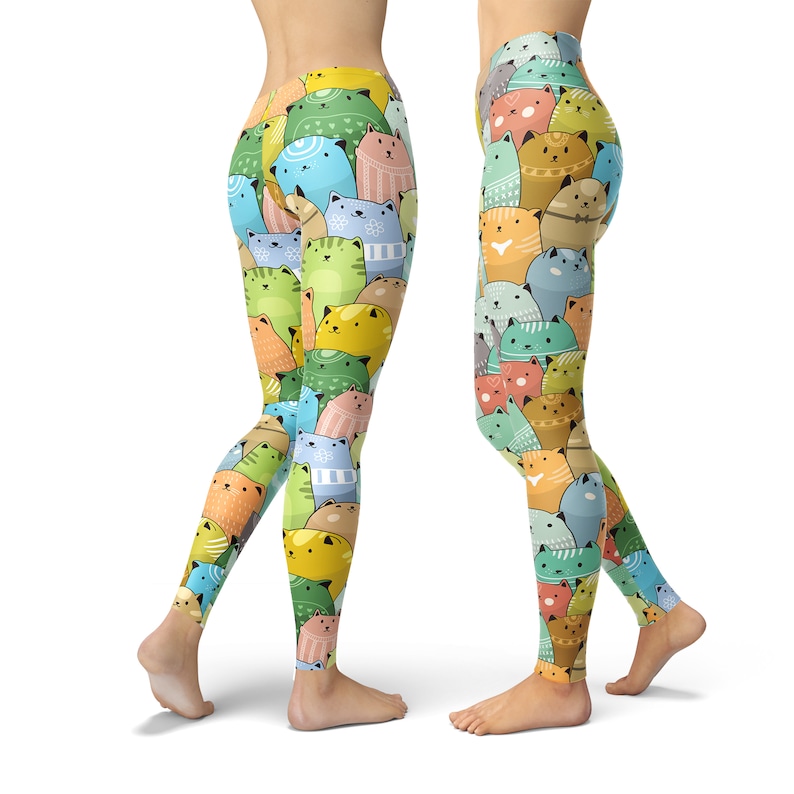 May include: A pair of colorful leggings with a repeating pattern of cartoon cats in various colors and poses. The leggings are a bright and cheerful design.