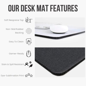May include: A black desk mat with a white border and a white mouse on top. The mat features a soft neoprene top, non-skid rubber backing, easy to clean surface, gamer-ready design, stain and spill resistance, and dye-sublimation print.