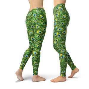 May include: Green leggings with a peacock feather pattern. The pattern features green, blue, and yellow colors.