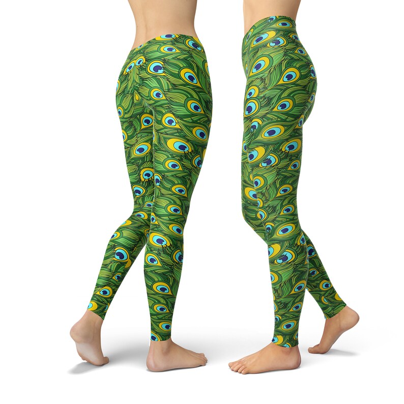 May include: Green leggings with a peacock feather pattern. The pattern features green, blue, and yellow colors.